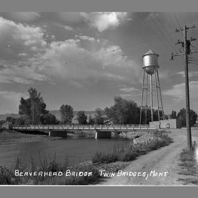 Black and white photo of the Beaverhead Bridge and water tower in Twin Bridges, Montana