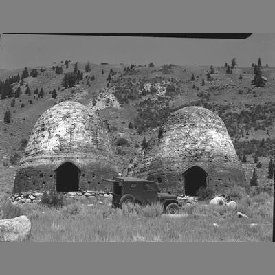 Two Charcoal Ovens with a Car Parked in front, Canyon Creek, Beaverhead County, 1955