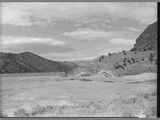 Dried-up reservoir for dam repairs, Madison County, Montana, 1955.