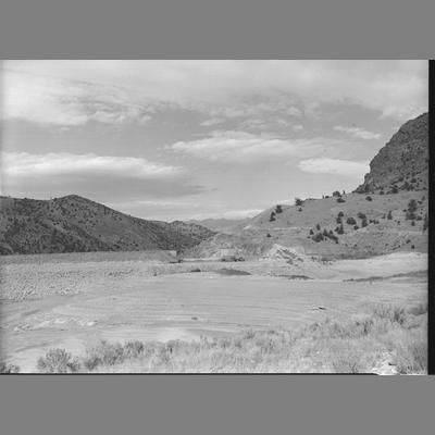 Dried-up reservoir for dam repairs, Madison County, Montana, 1955.