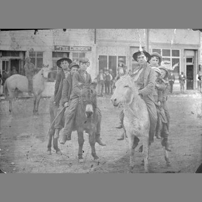 Boys on burros in front of 