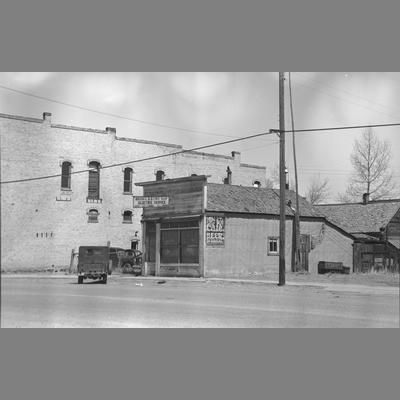 Brook's Electric Shop with trucks in front in Twin Bridges, Montana
