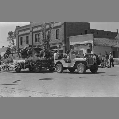 Jeep Pulling a Parade Float Decorated with Cut Grain on Main Street, Twin Bridges, Montana, August 19, 1956