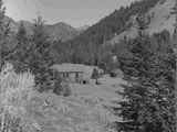 Abandoned Frame Building on Slope Leading Down to a Dirt Road in Nobelville, Wisconsin Creek, October 1960