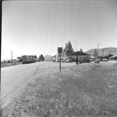 Small group of frame houses behind Texaco gas station in Armstead, Montana, July 1962.