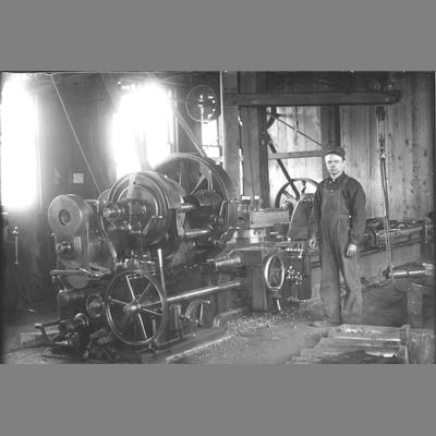 Ruby Lathe Standing Next to Elaborate Belt Driven Machine