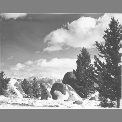 Large Boulders Rising from Snow Covered Clearing with Trees on the Right