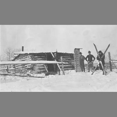 Men Displaying Sled and Skis in the Snow
