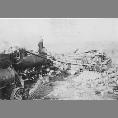 Two Men Operating a Saw Powered by a Belt Leading to a Steam Tractor circa 1890