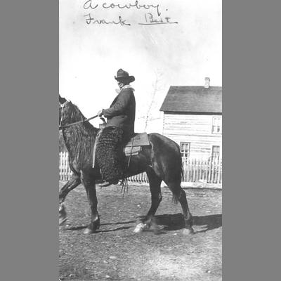 Cowboy Frank Best seen mounted on a horse in the early 20th century.