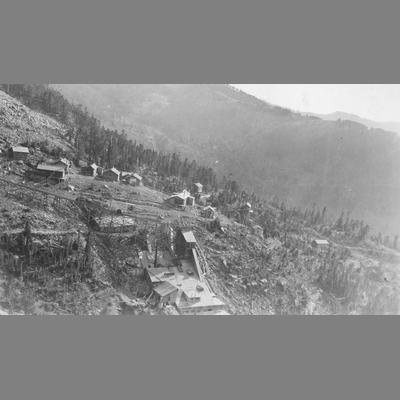 View of Scattered Cabins Perched on Side of Steep Mountain Canyon