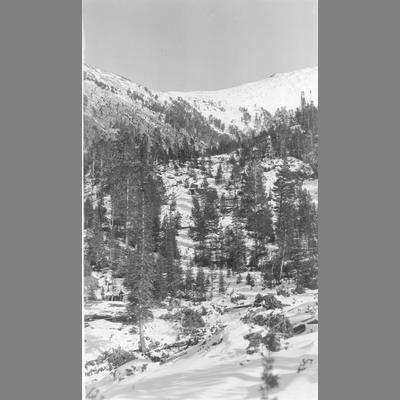 Snow Covered Mountain Canyon With Building Visible on the Far Right