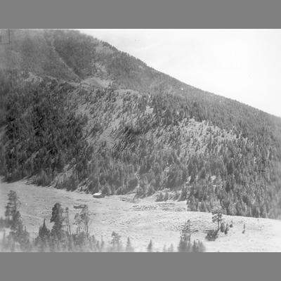 Mountain Clearing with Buildings Visible in the Middle Distance
