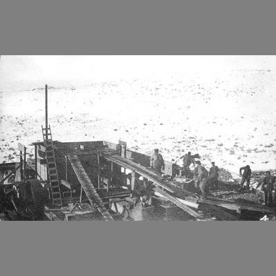 Overhead View of Workers Shoving Ore into Wooden Chute circa 1900