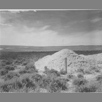 Post Stuck in Ground Directly in Front of Pile of White Dirt
