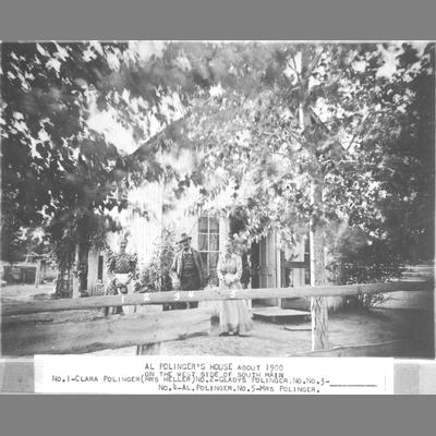 Two women and a man pose in front of Al Pollinger's House about 1900.