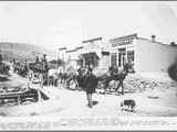 Wagons Pulled Up in Front of Wooden Frame Storefronts in Rochester ca. 1900s