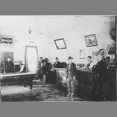 Inside View of Rochester Saloon's Barroom with Men Playing Billiards