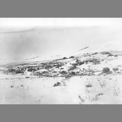 View of Small Town Built in the Snowy Foothills of Surrounding Mountains