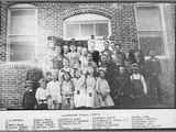 Brick Building of Silverstar School With Children Posing Outside 1900