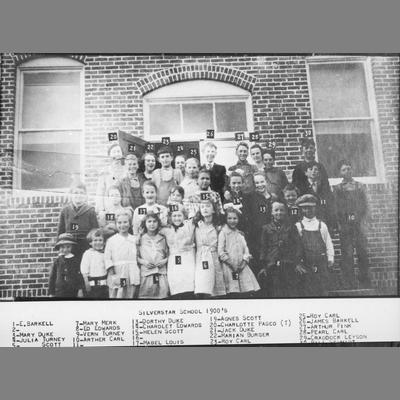 Brick Building of Silverstar School With Children Posing Outside 1900