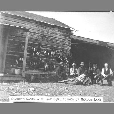 Five Men Pose With Shotguns and Dead Game Birds Next to Slade's Cabin