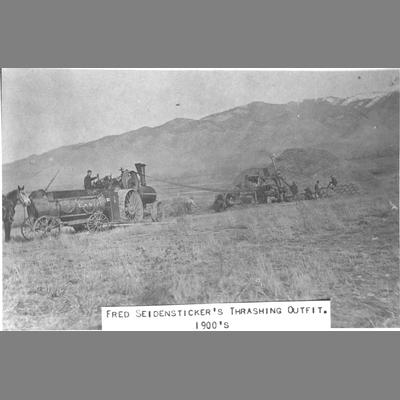 Steam-powered operating grain threshing machine, circa 1900s.
