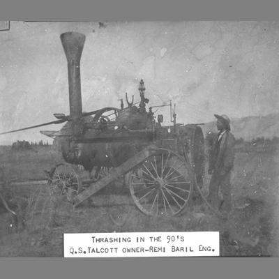 Man Stands Next to Steam Tractor in Open Field 1890