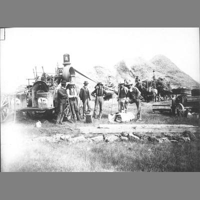 Gallatin Threshing - Six Men Posing Next to Steam Tractor Fitted with Machine Belting