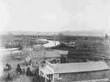 Elevated View of a Road Winding Past Buildings and Leading to Bridge in Twin Bridges, Montana