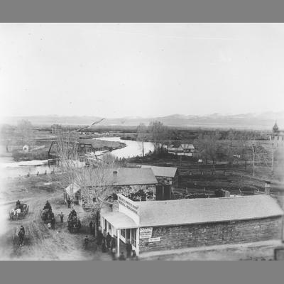 Elevated View of a Road Winding Past Buildings and Leading to Bridge in Twin Bridges, Montana