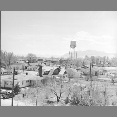 Twin Bridges with large water tower in center of town, 1920.