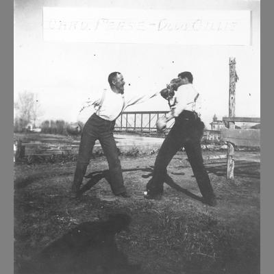 Two Men With Boxing Gloves Pose as if Exchanging Blows