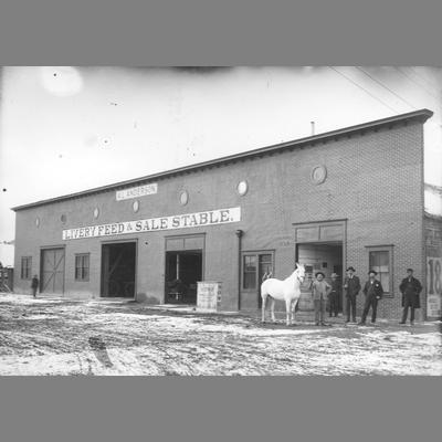 Six Men and White Horse Stand in Front of Anderson Stable circa 1890s