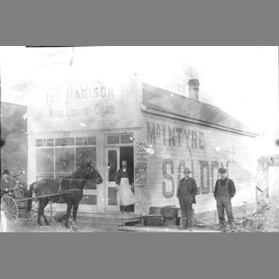 Bartender in Apron Standing in Doorway of McIntyre Saloon ca. 1890