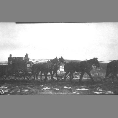 Sideview of heavy freight ore train pulled by six horse hitch.
