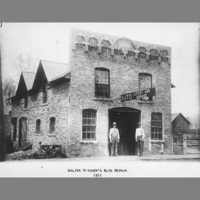Two Men Stand in Front of Pitcher's Auto Repair Shop, 1911