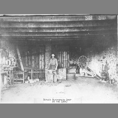 Scales Blacksmith Shop with a Blacksmith Posing at His Forge circa 1890s