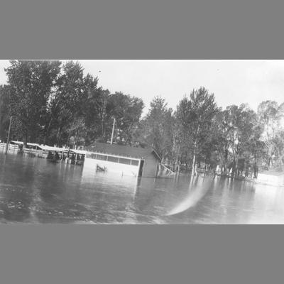 High water flood surrounding wood frame structure and adjoining corrals, June, 1927.