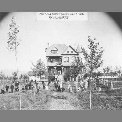 Children and Adults Pose in Front of Montana State Orphan