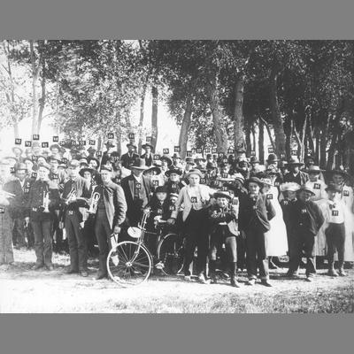 Uniformed Twin Bridges band members standing amidst a crowd.