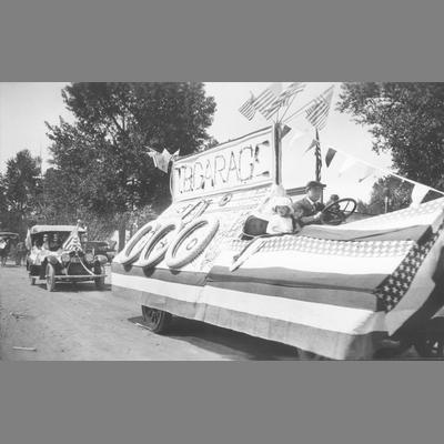 Man and Little Girl Driving Decorated Truck Advertising a Garage in Parade circa 1920