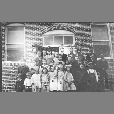 Students Pose With Teachers Outside of Brick Building in Twin Bridges, Montana 1920