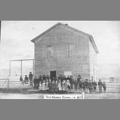 Group of Children and Children Stand in Front of Two Story Wood Frame Building, circa 1880s