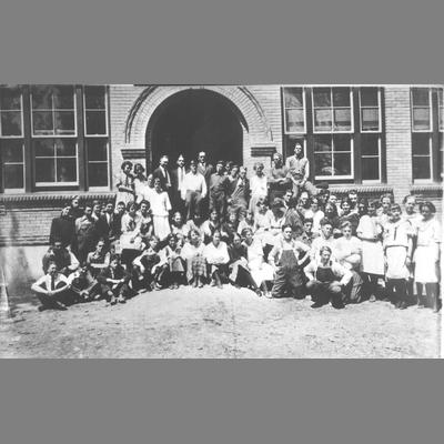 Teachers and Students Pose in Front of School, circa 1920s