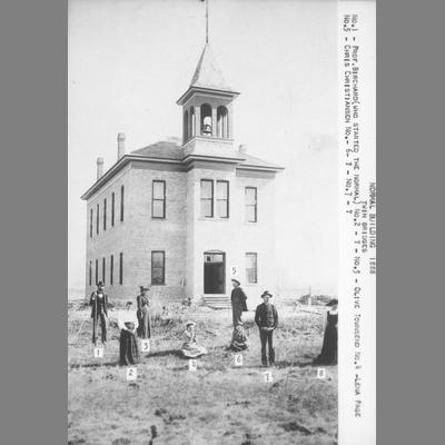 Teachers Pose in Front of Brick Building, 1888