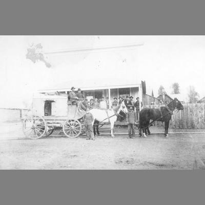 Stage Coach Parked in Front of a Wood Frame Commercial Building