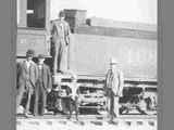 Four Men and a Boy Stand Along Side of a Steam Locomotive