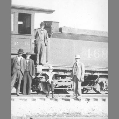 Four Men and a Boy Stand Along Side of a Steam Locomotive