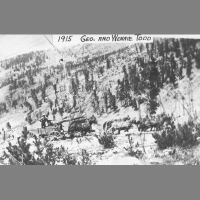 George and Wennie Todd riding in horse-drawn freight wagon, 1915.